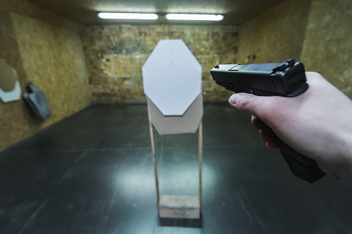 Tactical pistol shooting at a paper target at a shooting range. High quality photo