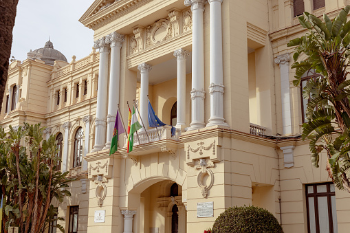 Malaga, Spain- 26-01-2024: Ornate entrance of the City Hall of Malaga with European flags, a perfect representation for governmental or historical content. Ayuntamiento de Malaga