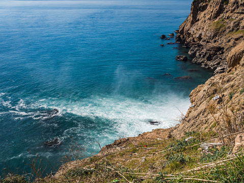 Aerial view of the Pacific Ocean crashing against the cliffs of the Oregon Coast at Neahkahnie Lookout.
