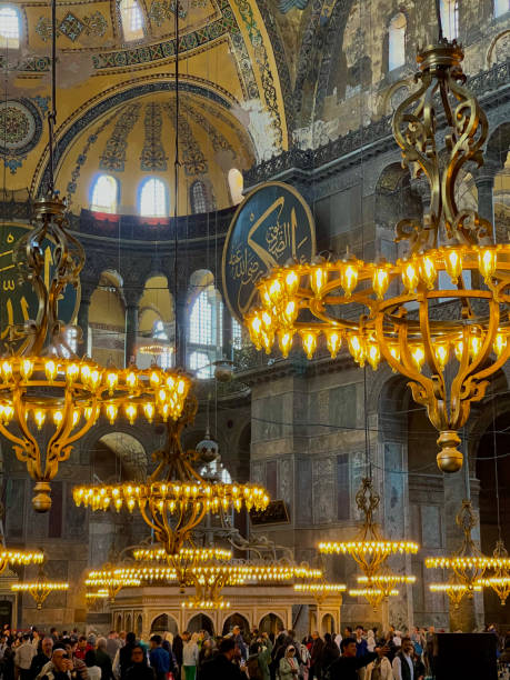 interior decoration of hagia sofia, beautiful chandeliers, frescoes and tourists - byzantine aya sofya light lighting equipment fotografías e imágenes de stock