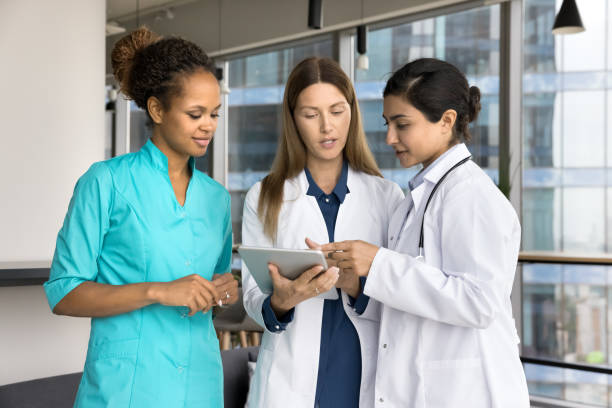 istock Diverse team of young doctors discussing medical application on tablet 1970135505