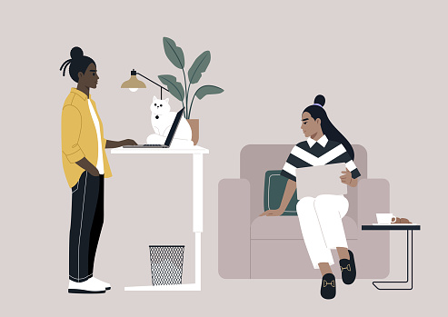 Diverse and personalized work setups at home and in the office, one young freelancer works with their desk intentionally adjusted to a standing position, while another comfortably sits in an armchair