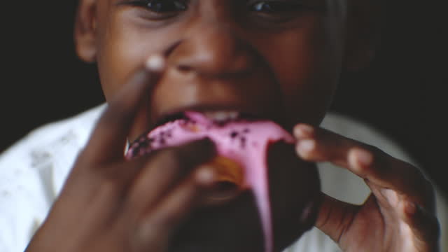 A boy eating doughnut