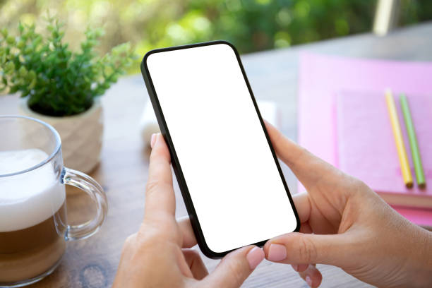 istock female hands hold phone with isolated screen on background cafe 1970167027