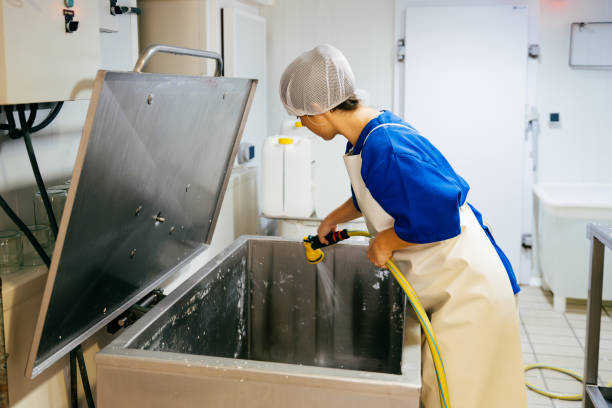 istock Factory worker washing tank for fermenting cheese 1970172318