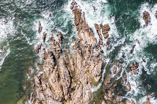 Texture of rocks by the ocean. Landscape of rocks over the ocean from a drone.