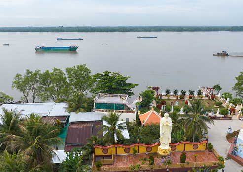 The pagoda is located on the banks of the Tien River with giant Buddha statues, Lien Hoa Pagoda, Tien Giang province, Vietnam