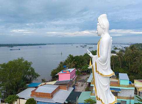 The pagoda is located on the banks of the Tien River with giant Buddha statues, Lien Hoa Pagoda, Tien Giang province, Vietnam