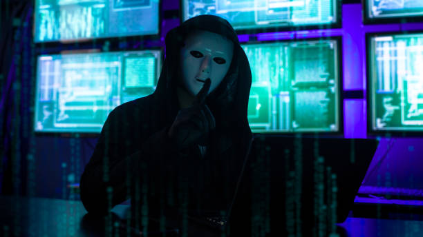 istock Wanted Hacker wearing a hoodie top and a Masked Face to hide his identity and using computer for hacking in the cyber data center 1970219505
