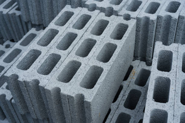 istock Stacks of concrete blocks ready for use in sturdy construction.  Grey concrete bricks piled, awaiting building and engineering work. 1970219509