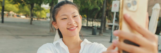 istock Young woman taking selfie on mobile phone, Panorama 1970255471