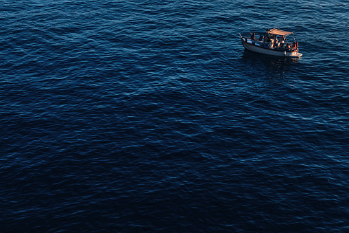 boat with tourists among the blue sea. sea trip. ripple on the s