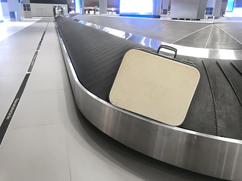 Luggage on a conveyor belt in arrival section of an airport