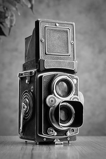 Saint John, NB, Canada - February 15, 2020: A Pentax film camera on a black table, with a black background.