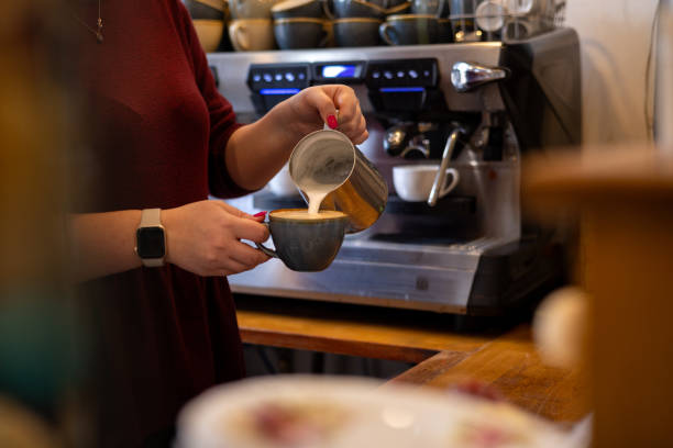 istock Pouring Milk in a Cup with Coffee 1970295359