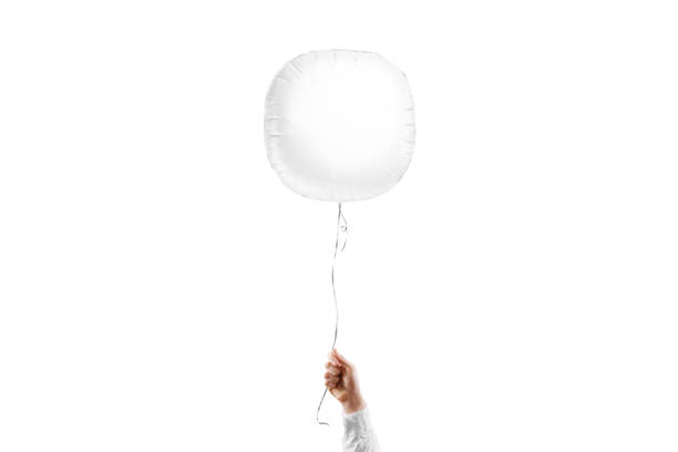 istock Hand holding blank white round balloon mockup, isolated 1970410825