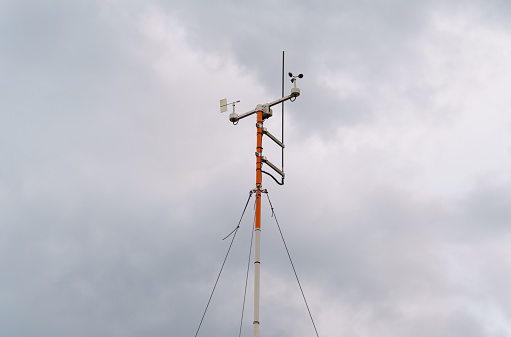 Weather station on the background of a stormy sky with clouds.