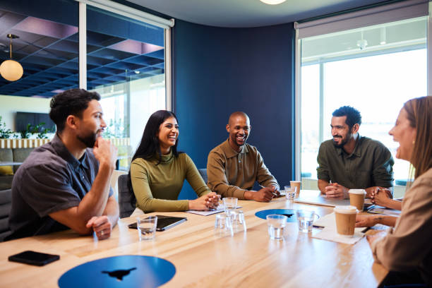 istock Smiling group of diverse businesspeople having a board room meeting 1970429992