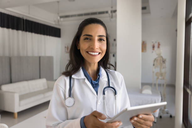 istock Cheerful beautiful doctor professional portrait with digital gadget 1970440628