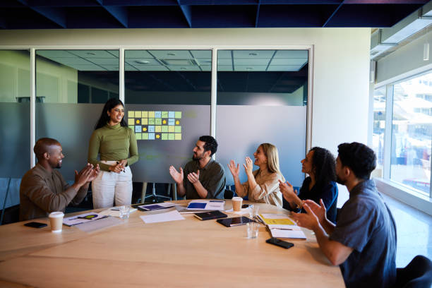 istock Smiling businesspeople clapping after a colleague's presentation in a board room 1970446594