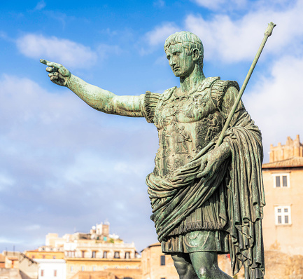 A bronze statue of Caesar gesturing during a speech, located on Via dei Fori Imperiali by the Roman Forum in central Rome.