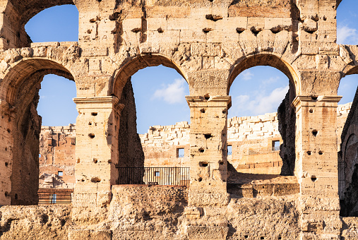 Looking through the arches across part of the Colosseum in Rome, Italy.