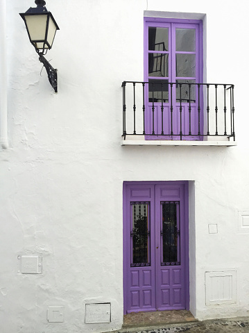 Colored balcony doors on the white wall. Spain.