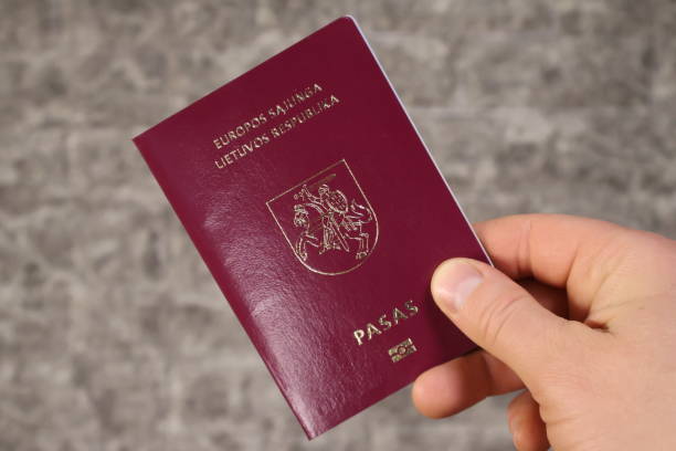 istock One Lithuanian passports are held in his hand. 1970475035
