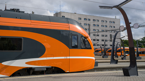 Tallinn, Estonia: Typical modern orange colored Estonian Trains in the Baltic Station - Balti Jaam in downtown Tallinn. Baltic Station the main railway station in Tallinn, Estonia, and the largest railway station in Estonia. All local commuter, long-distance and international trains depart from the station. Baltic Train Station, Tallinn, Estonia, Baltic Countries, Northern Europe.