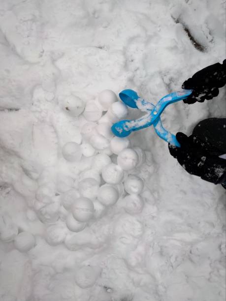 istock Snowballs on the heap and blue snowball maker 1970511357
