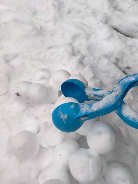 istock Snowballs on the heap and blue snowball maker 1970511360