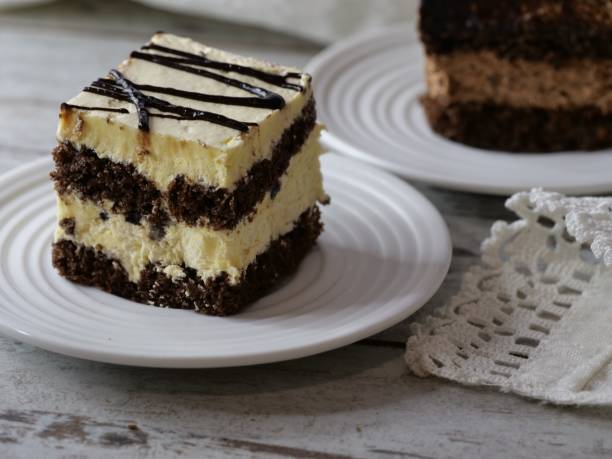 istock chocolate cake is on a plate next to a slice of cheesecake 1970536605