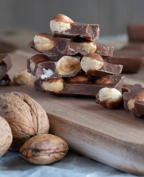 istock nuts and chocolate pieces on a wooden board with one bite taken out 1970537656