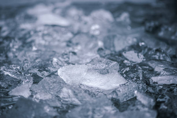 Cold water and ice cubes melting background. Global warming or climate change concept