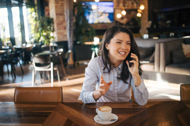 istock A charming woman with a beautiful smile is talking on a smartphone 1970568055