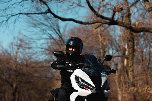 A Caucasian biker is spending his winter day by enjoying his ride time in the nature.