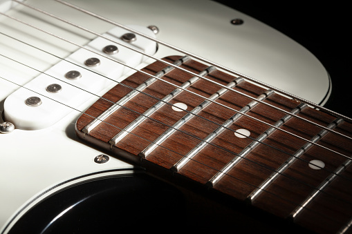 electric guitar fretboard body macro closeup