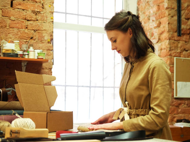 istock woman folds packing box in sewing workshop 1970572372