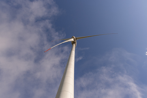 Renewable energy, Wind turbine against cloudy sky