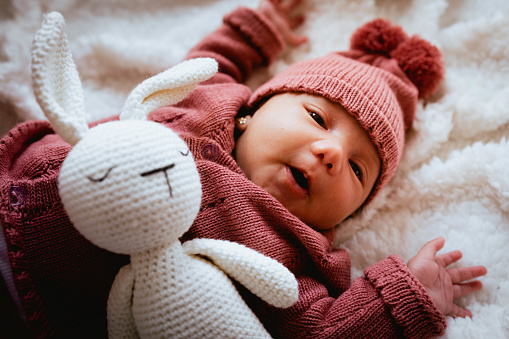 newborn baby with his stuffed bunny
