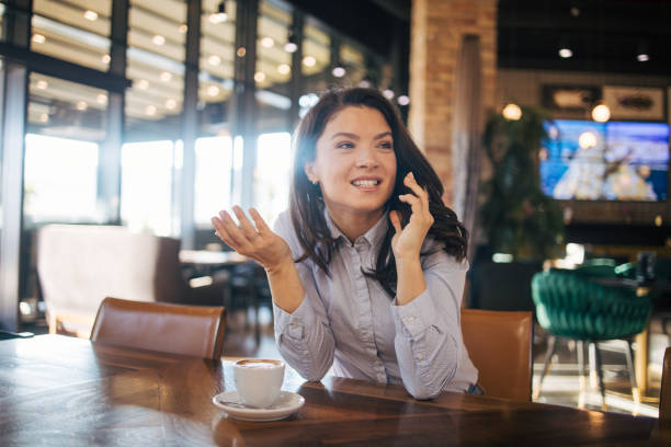 istock A charming woman with a beautiful smile is talking on a smartphone 1970594345