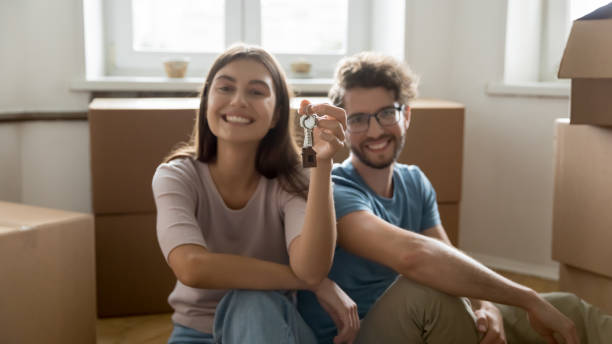 istock Couple showing keys from their new bought or rented flat 1970611641