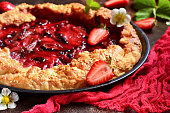 Close-up of strawberry pie, pastries, strawberries, dough, sesame seeds, background