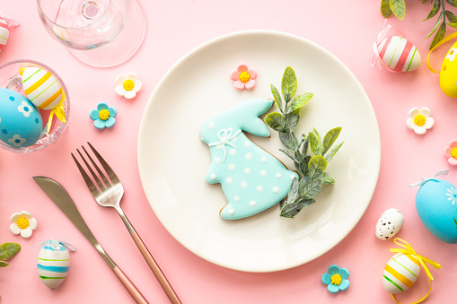 Easter food background with holiday decorations. Easter table setting. Flat lay on blue.