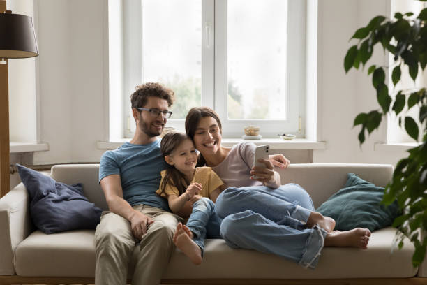 istock Family spend time at home use mobile phone 1970643778