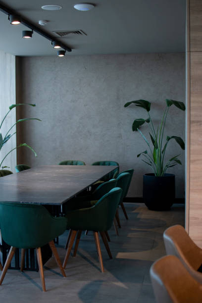 istock a large table is surrounded by chairs and potted plants 1970645971
