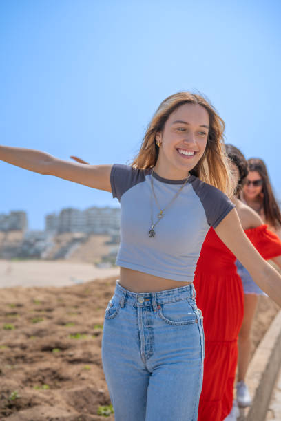 istock Friends laughing with their arms outstretched 1970654437