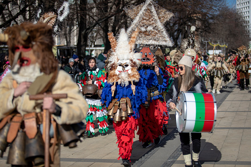 Pernik, Bulgaria - January 27, 2024: 30th anniversary Masquerade festival in Pernik Bulgaria. People with a mask called Kukeri dance and perform to scare the evil spirits.