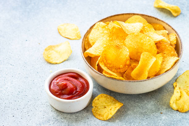 istock Potato chips in the bowl and ketchup sauce. 1970662984