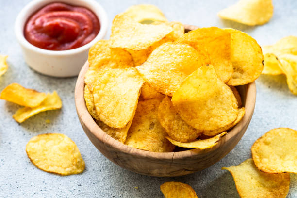 istock Potato chips in the bowl and ketchup sauce. 1970662989